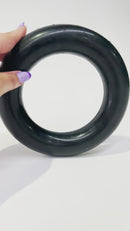 Pet owner holding the Strong Rubber Ring, demonstrating its easy-to-grip design and large size for interactive play